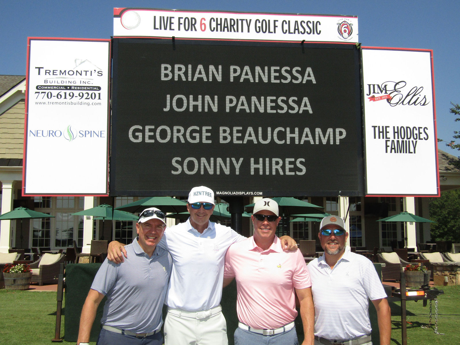 A different Live for 6 foursome gathered at the tournament scoreboard