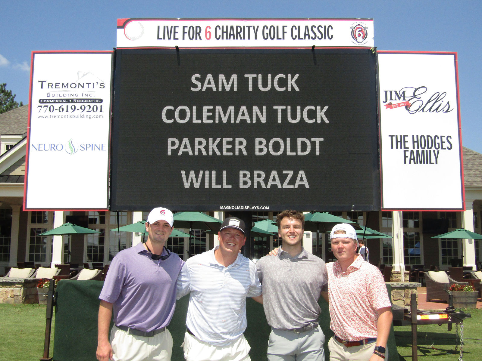 A Live for 6 foursome smiling together at the Charity Golf Classic