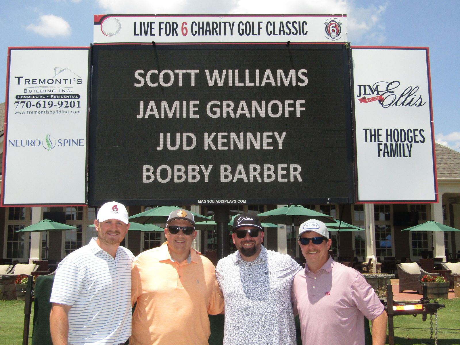 Friends smiling for a team portrait at the charity classic
